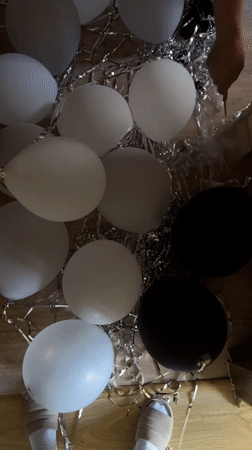 Person pops balloons amid food market activity in Ternopil