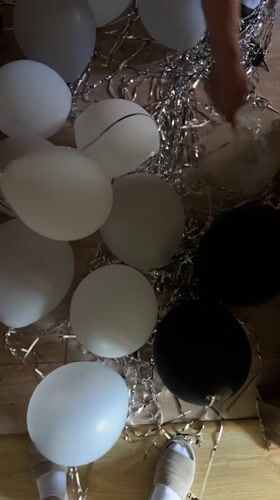 Person pops balloons amid food market activity in Ternopil