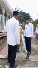 Men in religious attire conduct surveying work in Blangriek