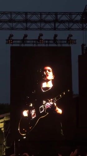 Male musician performs on outdoor concert screen in Paris