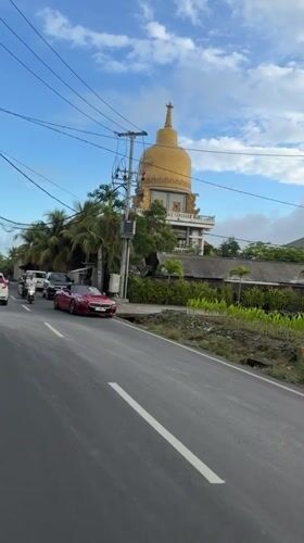 Traffic flows past golden-domed building in Mengwi, Indonesia