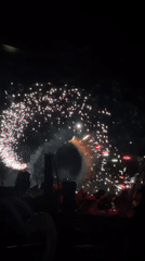 Nighttime street celebration features fireworks, DJ performances, crowds