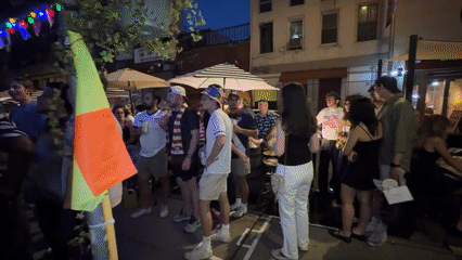 Late-night outdoor gathering features patriotic attire in New York