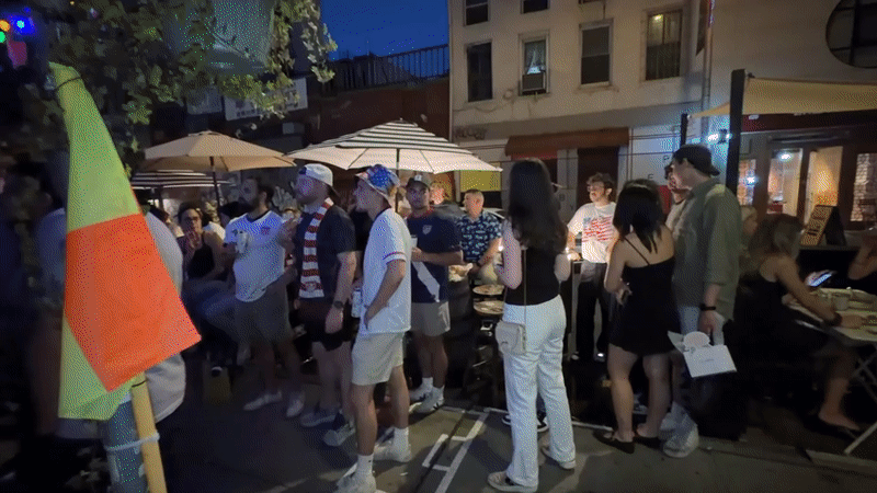 Late-night outdoor gathering features patriotic attire in New York