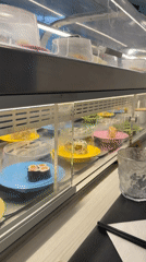 Conveyor belt sushi rolling through a Vevey restaurant