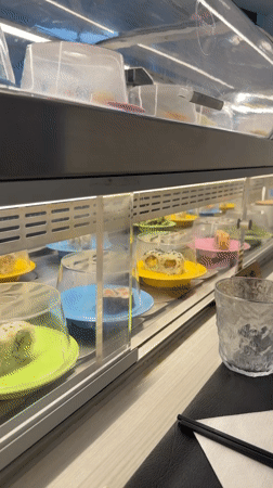 Conveyor belt sushi rolling through a Vevey restaurant