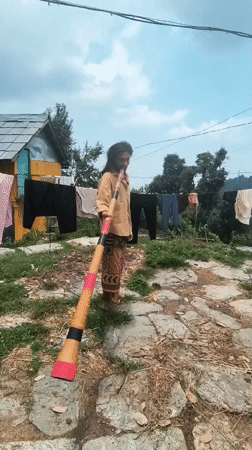 Morning practice with instrument and staff in a Himalayan village