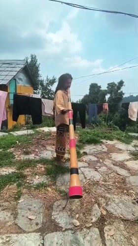 Morning practice with instrument and staff in a Himalayan village