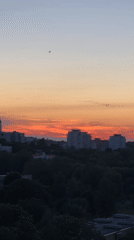 Minsk at golden hour: apartment skylines and peony blooms
