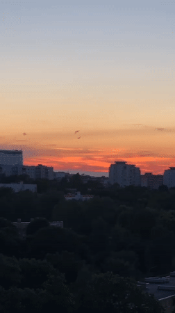 Minsk at golden hour: apartment skylines and peony blooms