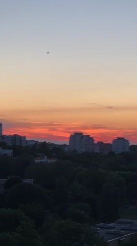 Minsk at golden hour: apartment skylines and peony blooms