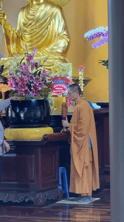Monk performs early morning temple rituals in Da Lat
