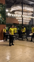 Street drummers perform outside restaurant in Tangier evening