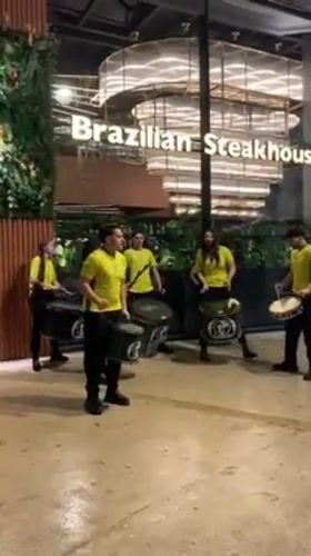 Street drummers perform outside restaurant in Tangier evening
