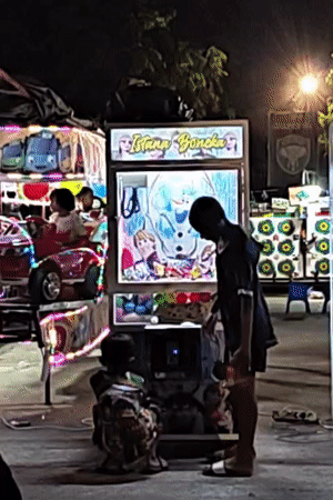 Children enjoy nighttime fair activities in Lhokseumawe, Indonesia
