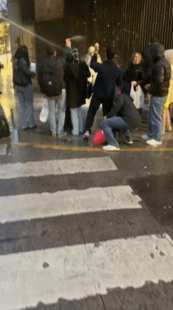 Street gathering with spray cans in Buenos Aires at night
