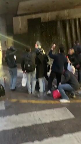 Street gathering with spray cans in Buenos Aires at night