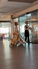 Traditional folk performance with costumed dancers entertains children in Sicily