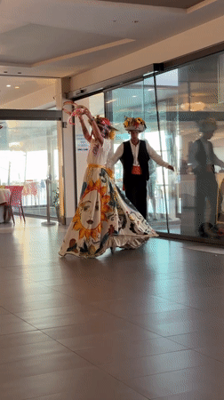 Traditional folk performance with costumed dancers entertains children in Sicily