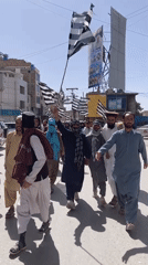 Political procession with striped flags marches through Quetta streets