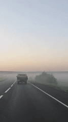 Truck travels foggy dawn road in Izhevsk, Russia