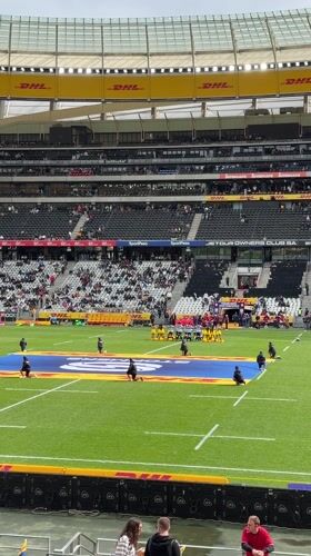Rugby match observed at Cape Town stadium during overcast afternoon