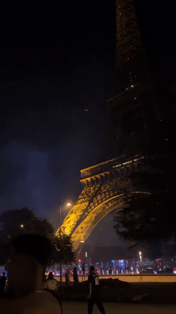 Fireworks draw crowds near Eiffel Tower as emergency vehicles respond