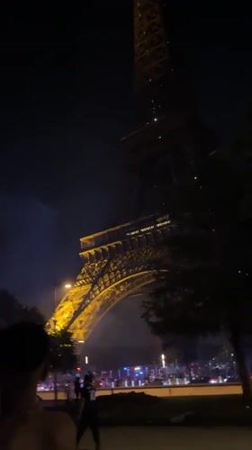 Fireworks draw crowds near Eiffel Tower as emergency vehicles respond