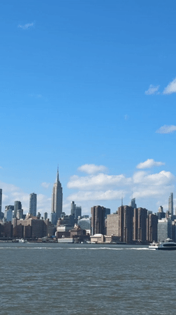 NYC skyline viewed from waterfront on clear April evening