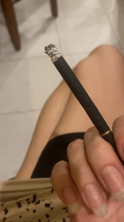 Person smoking cigarette captured in North Kuta, Indonesia