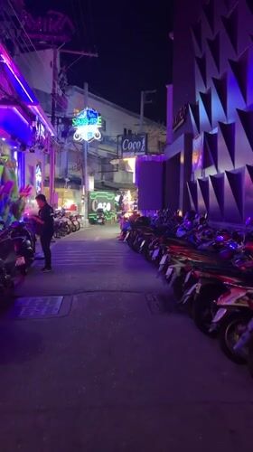 Nighttime scenes captured in Pattaya entertainment district alleyway