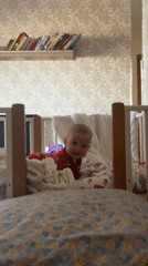 Baby in red pajamas observed in crib in Sochi