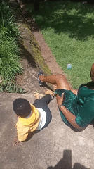 Woman and child interact near church in Maua ward