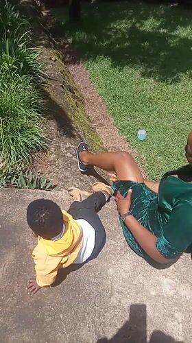 Woman and child interact near church in Maua ward