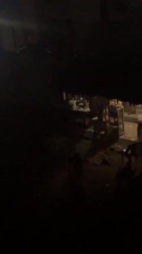 Nighttime gathering of residents on street corner in Ihiagwa