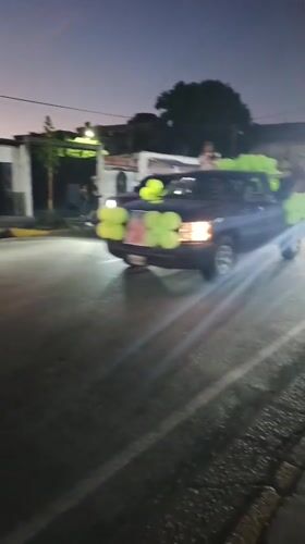 Decorated truck parade winds through Tinaquillo streets at dusk