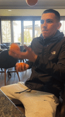 Man juggles tangerines in Bulgarian restaurant dining area