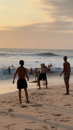 Surfing, swimming, and beach activity at Kuta Selatan.