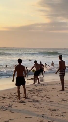 Surfing, swimming, and beach activity at Kuta Selatan.