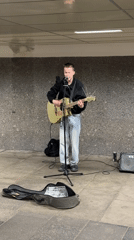 Street musician performs underground in Moscow evening