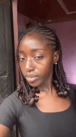 Woman poses for camera in Abuja indoor setting