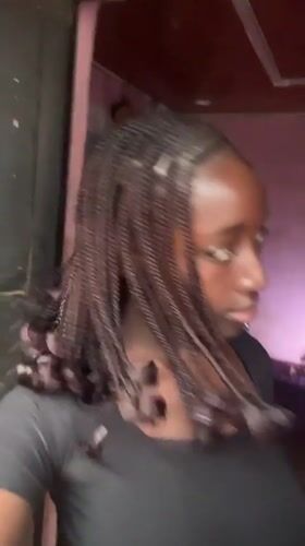 Woman poses for camera in Abuja indoor setting