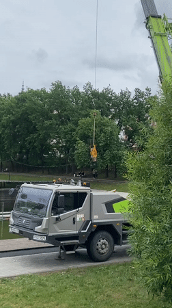 Crane operates at pond edge in Kazan