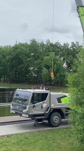 Crane operates at pond edge in Kazan