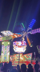 Late night carnival scene in Cascais with rides and food stalls