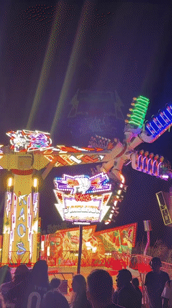Late night carnival scene in Cascais with rides and food stalls
