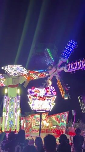 Late night carnival scene in Cascais with rides and food stalls