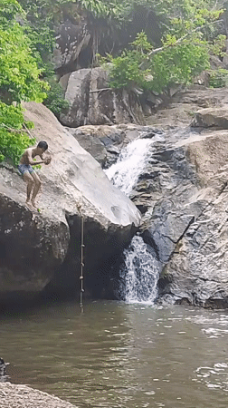 Young People Cliff Jump at Thailand Waterfall During Morning Recreation