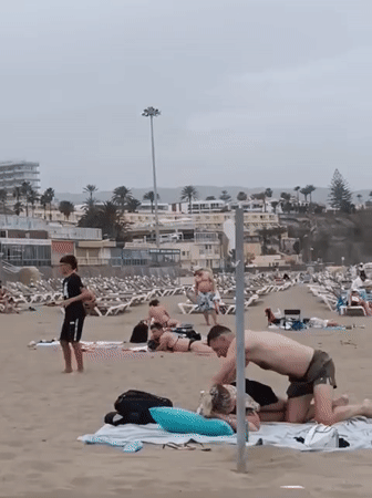 Beachgoers enjoy overcast day at Gran Canaria beach