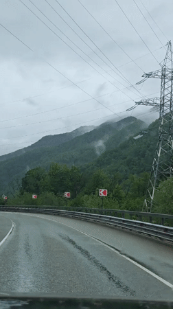 Vehicle travels two-lane road in Krasnaya Polyana, Russia